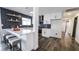 Stylish kitchen featuring white cabinets, stainless steel appliances, breakfast bar, and dark backsplash extending into the dining area at 4308 San Bernardino Ave, Las Vegas, NV 89102