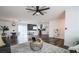 Open concept living room with modern lighting, ceiling fan, hardwood floors, and seamless flow into the kitchen and dining areas at 4308 San Bernardino Ave, Las Vegas, NV 89102