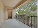 Outdoor balcony provides a cozy seating area with views of the surrounding foliage at 4615 Puglia Ln # 201, North Las Vegas, NV 89084