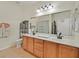 Bathroom features double sinks, vanity with storage and large mirror at 4615 Puglia Ln # 201, North Las Vegas, NV 89084