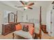 Cozy bedroom with a four-poster bed, dresser, and a plush bench at 4615 Puglia Ln # 201, North Las Vegas, NV 89084