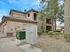 Exterior view of a well-maintained condo building with desert landscaping and a cluster mailbox for residents at 4615 Puglia Ln # 201, North Las Vegas, NV 89084