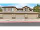 Beautiful condo building featuring attached garages and well-maintained landscaping at 4615 Puglia Ln # 201, North Las Vegas, NV 89084