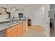 Bright kitchen features tile floors, double sink, and wood cabinets at 4615 Puglia Ln # 201, North Las Vegas, NV 89084