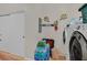 Functional laundry room with modern washer and dryer, Raiders décor, and convenient storage at 4615 Puglia Ln # 201, North Las Vegas, NV 89084