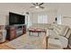 Bright living room featuring a ceiling fan, large windows, and comfortable seating at 4615 Puglia Ln # 201, North Las Vegas, NV 89084