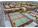 Aerial view of community featuring tennis courts, a swimming pool, lush landscaping, and surrounding residential buildings at 5097 Indian River Dr # 172, Las Vegas, NV 89103