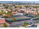 Aerial view of community featuring tennis courts, a swimming pool, lush landscaping, and palm tree-lined streets at 5097 Indian River Dr # 172, Las Vegas, NV 89103