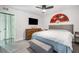 Bright bedroom with ceiling fan, mounted TV, dresser, and Asian-themed wall decor at 5097 Indian River Dr # 172, Las Vegas, NV 89103