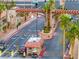 Community entrance with lush landscaping, palm trees, and controlled gate access at 5097 Indian River Dr # 172, Las Vegas, NV 89103