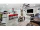 Open-concept living space featuring an island with seating, modern fireplace, and sleek, neutral decor at 5097 Indian River Dr # 172, Las Vegas, NV 89103