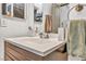 This bathroom features a white countertop, wood cabinets and a neutral color scheme at 5157 Garden Ln # F, Las Vegas, NV 89119