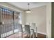 Bright dining area with a table for four and a sliding door for outdoor access at 5157 Garden Ln # F, Las Vegas, NV 89119