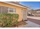 A charming tan townhouse featuring well-kept landscaping and a secure front door at 5157 Garden Ln # F, Las Vegas, NV 89119