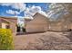 A row of townhouses with well-maintained gravel landscaping and mature trees on a sunny day at 5157 Garden Ln # F, Las Vegas, NV 89119