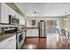 Bright kitchen featuring granite countertops, stainless steel appliances, and eat-in dining area at 5157 Garden Ln # F, Las Vegas, NV 89119