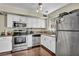 Updated kitchen featuring stainless steel appliances and white cabinetry, creating a bright and modern space at 5157 Garden Ln # F, Las Vegas, NV 89119