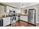 Bright kitchen featuring granite countertops, stainless steel appliances, and white cabinets at 5157 Garden Ln # F, Las Vegas, NV 89119