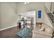 Bright living room with vaulted ceilings, wood floors, staircase and view to kitchen at 5157 Garden Ln # F, Las Vegas, NV 89119