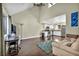Bright living room with vaulted ceilings, ceiling fan, wood floors and work desk at 5157 Garden Ln # F, Las Vegas, NV 89119
