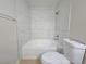Bright bathroom features tub with stylish marble-look tile surround and a modern toilet at 5161 Lindell Rd # 104, Las Vegas, NV 89118