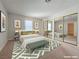 Staged bedroom with large windows, mirrored closets and neutral carpeting at 5161 Lindell Rd # 104, Las Vegas, NV 89118