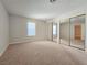 Bedroom featuring natural light, neutral carpeting and mirrored closet at 5161 Lindell Rd # 104, Las Vegas, NV 89118