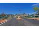 Gated community entrance with desert landscaping and well-maintained buildings on a bright, sunny day at 5161 Lindell Rd # 104, Las Vegas, NV 89118