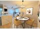 Stylish dining area next to a modern kitchen featuring a quartz breakfast bar and stainless-steel appliances at 5161 Lindell Rd # 104, Las Vegas, NV 89118