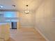 Dining area with modern cabinets, stainless steel appliances, and wood-style flooring at 5161 Lindell Rd # 104, Las Vegas, NV 89118