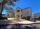 Apartment building with well-maintained landscaping and a parking area, under a clear blue sky at 5161 Lindell Rd # 104, Las Vegas, NV 89118