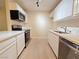 Bright kitchen features white cabinets, stone countertops, stainless steel appliances, and modern track lighting at 5161 Lindell Rd # 104, Las Vegas, NV 89118