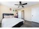 Comfortable bedroom with a bed and ceiling fan, showcasing a closet and access to other rooms at 6177 W Cougar Ave, Las Vegas, NV 89139