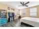 Bright bedroom with natural light from two windows, ceiling fan, and a queen bed at 6177 W Cougar Ave, Las Vegas, NV 89139