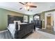 Well-lit bedroom featuring dark-wood furniture, neutral walls, and hardwood floors at 6177 W Cougar Ave, Las Vegas, NV 89139