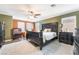 Spacious bedroom featuring decorative, dark-wood furniture, neutral walls, and ample natural light at 6177 W Cougar Ave, Las Vegas, NV 89139
