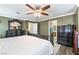 Well-lit bedroom featuring dark-wood furniture, neutral walls, and hardwood floors at 6177 W Cougar Ave, Las Vegas, NV 89139