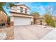 Charming two-story home featuring a paved driveway and a well-maintained front yard at 6177 W Cougar Ave, Las Vegas, NV 89139