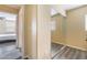 Hallway with mirrored closet doors leading to a brightly lit bedroom at 6177 W Cougar Ave, Las Vegas, NV 89139