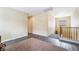 Upstairs hallway with wood laminate flooring and access to other rooms in the home at 6177 W Cougar Ave, Las Vegas, NV 89139
