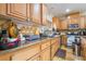 Spacious kitchen featuring wood cabinets, granite countertops and stainless steel appliances at 6177 W Cougar Ave, Las Vegas, NV 89139