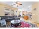 Open-concept living area featuring a comfortable gray sofa, adjacent to the kitchen and dining area at 6177 W Cougar Ave, Las Vegas, NV 89139