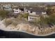 Aerial view showcasing the sprawling property with desert landscaping and circular driveway at 64 Promontory Ridge Dr, Las Vegas, NV 89135