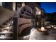 Outdoor living space featuring a built-in bench, stairs, a fireplace, and stone accents at 64 Promontory Ridge Dr, Las Vegas, NV 89135