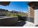 A modern home balcony with mountain views and stone accents provides a luxurious outdoor retreat at 64 Promontory Ridge Dr, Las Vegas, NV 89135