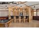 Entertaining bar with custom woodwork, seating, and a stylish countertop perfect for gatherings at 64 Promontory Ridge Dr, Las Vegas, NV 89135