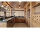 Custom-built bar featuring wood cabinetry, stainless steel under-counter refrigerator, and ample counter space at 64 Promontory Ridge Dr, Las Vegas, NV 89135