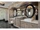 Bathroom showcasing double sinks, decorative mirrors, and shower at 64 Promontory Ridge Dr, Las Vegas, NV 89135