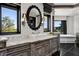 Elegant bathroom featuring marble countertops, decorative mirror, and a soaking tub with picturesque window views at 64 Promontory Ridge Dr, Las Vegas, NV 89135