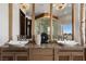 The bathroom vanity features and sinks, decorative lighting, and contemporary faucets at 64 Promontory Ridge Dr, Las Vegas, NV 89135